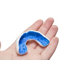 Person holding a custom made mouthguard