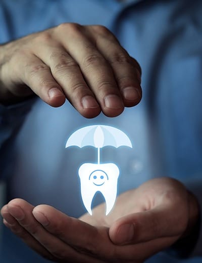 Hands holding hologram of a tooth under an umbrella