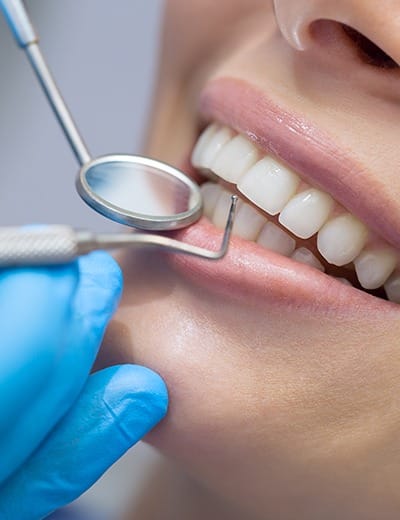 Close up of dental patient receiving scaling and root planing