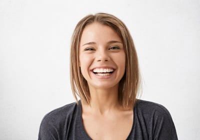 girl smiling after getting veneers in North Dallas