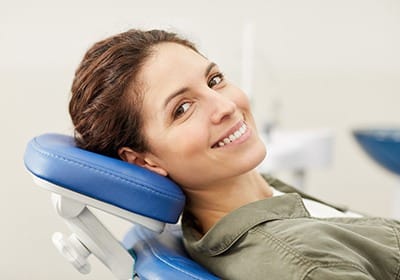 Smiling woman in dental chair during preventive dentistry visit