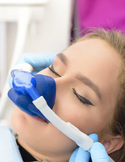 Woman in dental chair with nitrous oxide nasal mask