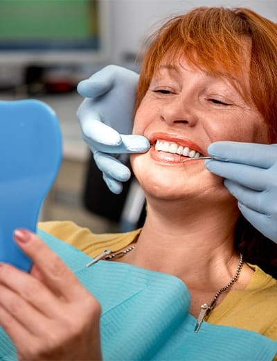 Smiling senior woman in dental chair