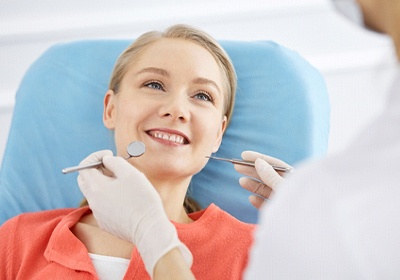Happy young woman visiting her Aetna dentist in North Dallas