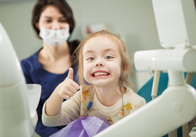 Child smiling in the dental chair