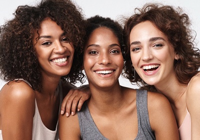 Three women smiling after visiting Cigna dentist in North Dallas