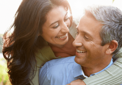 Smiling couple with dental implants in North Dallas