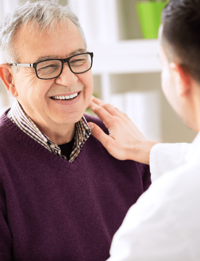 Smiling man speaking to his implant dentist