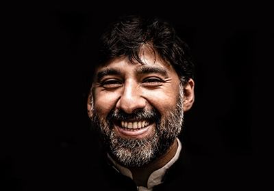 a man smiling on black background with dentures in North Dallas