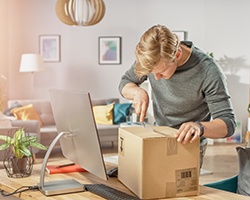 Man using tool to open a package