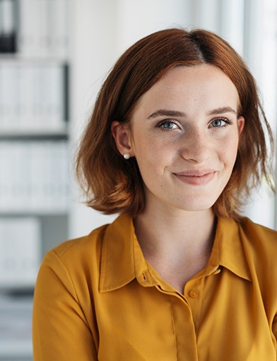 Woman smiling inside an office