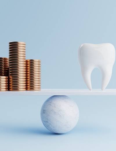 Tooth balanced against stacks of coins