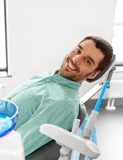 Smiling man leaning back in dental chair