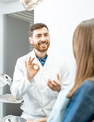 Dentist and patient discussing candidacy for full mouth reconstruction