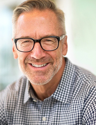 Older man smiling with dental implants in Dallas