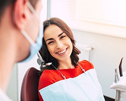 young woman smiling at her dentist