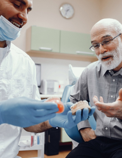 Dentist and patient engaged in animated conversation
