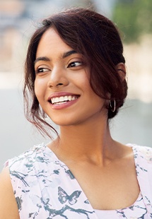 smiling woman with black and white flowery blouse