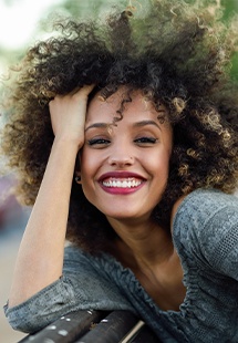 smiling woman resting her head in her hand