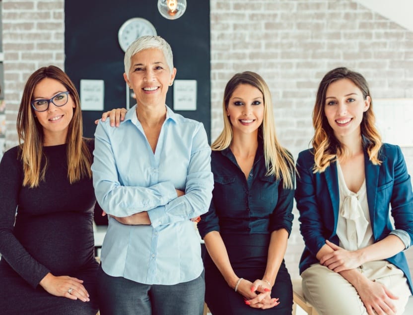 Several smiling dental office team members
