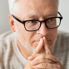 Man wearing glasses and thinking