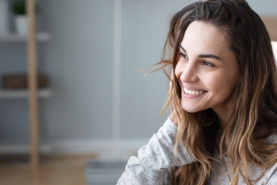 Woman with long brown hair smiling