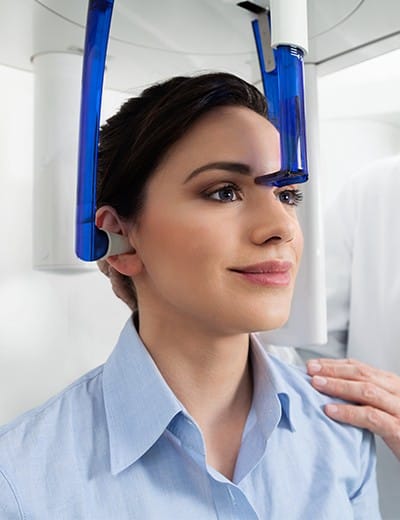Woman receiving 3 D C T scan of her mouth and jaw
