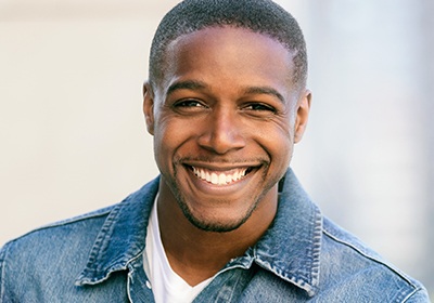 Smiling man in denim jacket