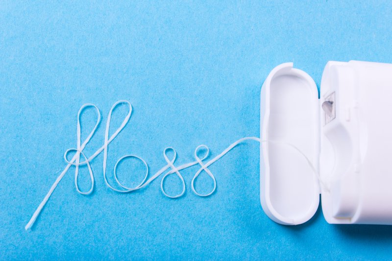 The word ‘floss’ written out of dental floss