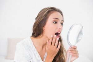 Woman looking at her loose tooth